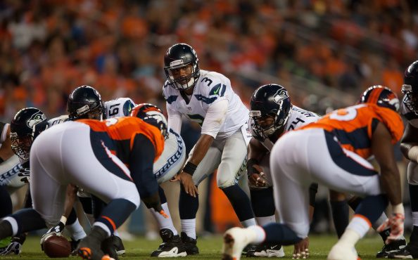 Quarterback Russell Wilson #3 of the Seattle Seahawks waits for the snap as he runs the offense aga...