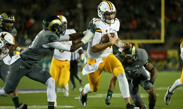 FORT COLLINS, CO - OCTOBER 1:  Quarterback Josh Allen #17 of the Wyoming Cowboys splits the defense...