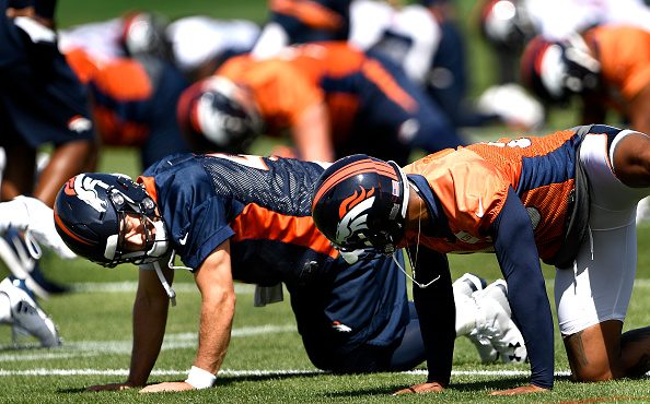 Denver Broncos quarterback Case Keenum (4) talking with wide receiver Demaryius Thomas (88) during ...