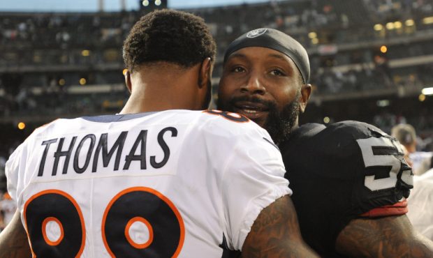 OAKLAND, CA - NOVEMBER 26:  Demaryius Thomas #88 of the Denver Broncos hugs NaVorro Bowman #53 of t...