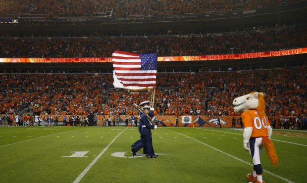 DENVER, CO - SEPTEMBER 11:  The flags are carried off the field following the National Anthem befor...