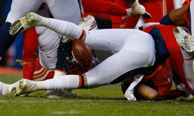 DENVER, CO - DECEMBER 31:  Quarterback Paxton Lynch #12 of the Denver Broncos fumbles the football ...