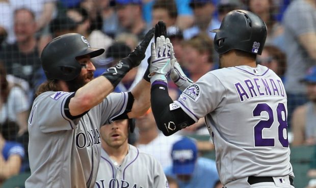 CHICAGO, IL - MAY 02:  Nolan Arenado #28 of the Colorado Rockies is congratulated by Charlie Blackm...