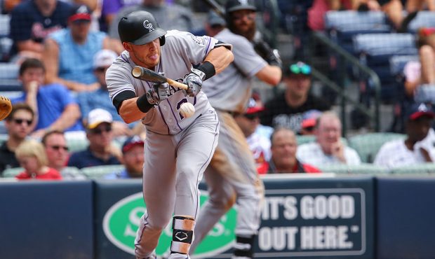 ATLANTA, GA - JULY 17: Trevor Story #27 of the Colorado Rockies bunts against the Atlanta Braves in...