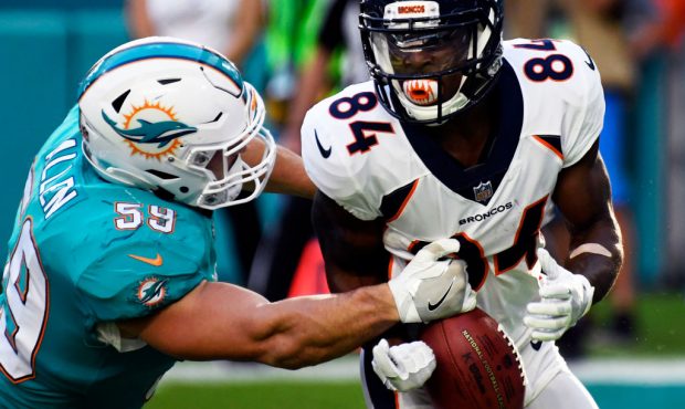 Outside linebacker Chase Allen (59) of the Miami Dolphins gets to wide receiver Isaiah McKenzie (84...