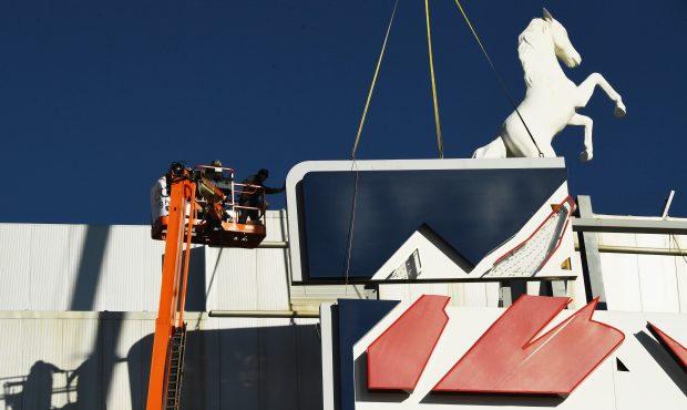 Crews remove the Sports Authority sign at the Broncos stadium on Jan. 11, 2018 in Denver. (Photo by...