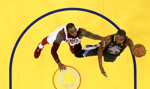 Kevin Durant #35 of the Golden State Warriors attempts a layup against LeBron James #23 of the Clev...