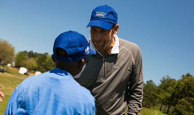 DULUTH, GA - APRIL 16: Former Atlanta Braves Pitcher John Smoltz greets the child he is playing for...