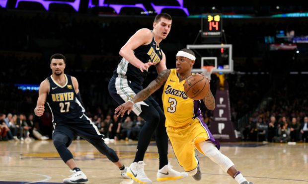 Isaiah Thomas #3 of the Los Angeles Lakers gets around Nikola Jokic #15 of the Denver Nuggets on Ma...