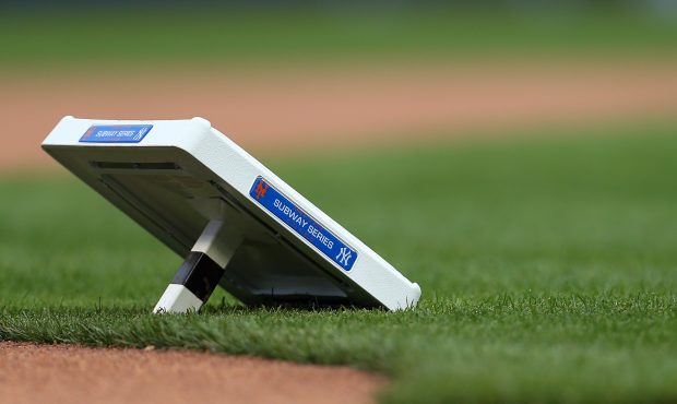 Bases adorned with commemorative plaques for the Subway Series wait to be set before a game between...