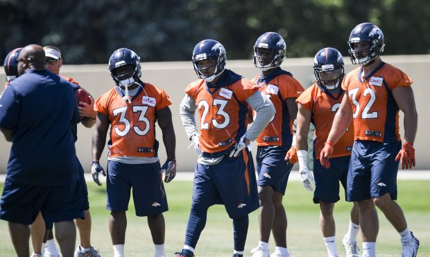 Denver Broncos running backs from left to right De'Angelo Henderson Sr., Devontae Booker (23), Davi...