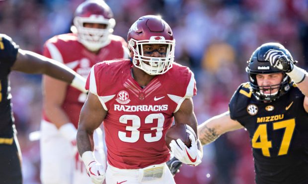FAYETTEVILLE, AR - NOVEMBER 24:  David Williams #33 of the Arkansas Razorbacks runs the ball in for...