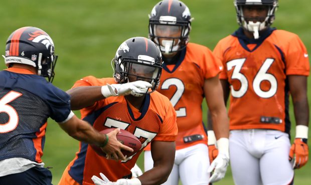 Quarterback Chad Kelly (6) hands off to running back Royce Freeman (37) on Day 2 of Denver Broncos ...