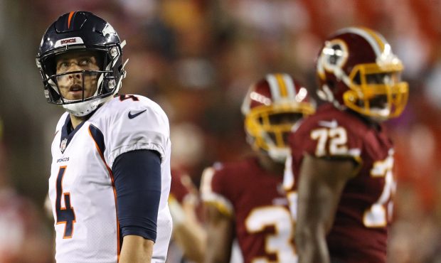 Quarterback Case Keenum #4 of the Denver Broncos looks on against the Washington Redskins in the fi...