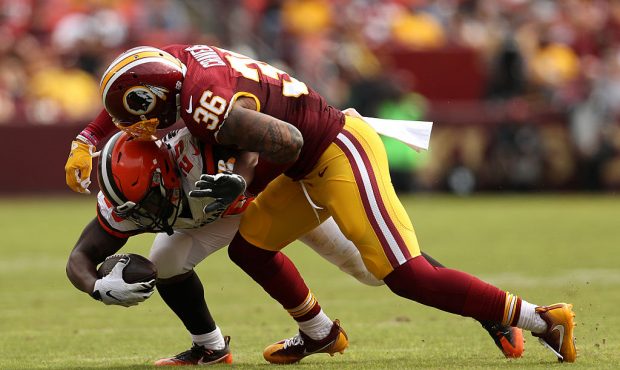 LANDOVER, MD - OCTOBER 2: Running back George Atkinson #25 of the Cleveland Browns is tackled by de...
