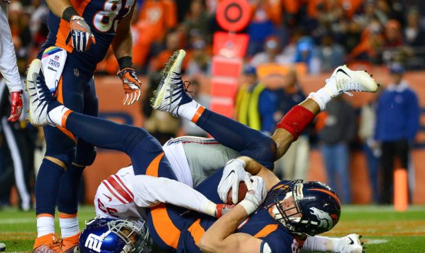 DENVER, CO - OCTOBER 15:  Tight end Jeff Heuerman #82 of the Denver Broncos is brought down in the ...
