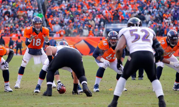 DENVER, CO - JANUARY 12:  Peyton Manning #18 of the Denver Broncos calls signals out in the shotgun...