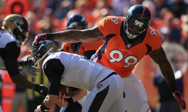 DENVER, CO - OCTOBER 13:  Defensive tackle Kevin Vickerson #99 of the Denver Broncos gets a hand on...