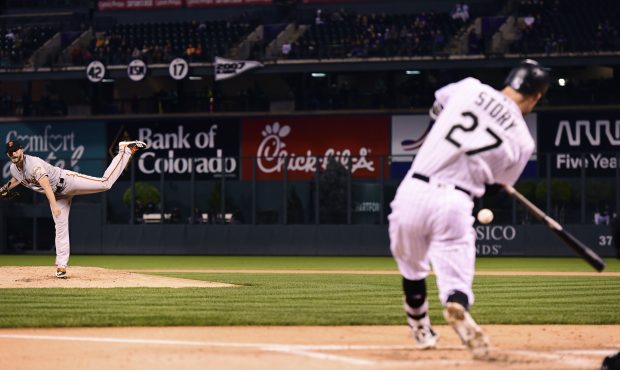 Trevor Story #27 of the Colorado Rockies hits a home run off a pitch from Andrew Suarez #59 of the ...