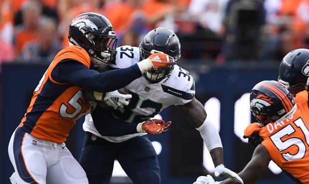 Denver Broncos linebacker Von Miller (58) strips the ball from Seattle Seahawks running back Chris ...