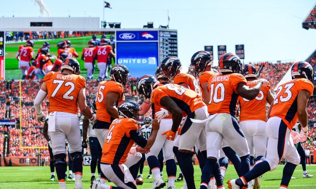 The Denver Broncos offense huddles around quarterback Case Keenum #4 during a game against the Seat...