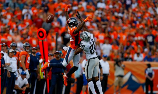Wide receiver Demaryius Thomas #88 of the Denver Broncos misses a reception under coverage by defen...