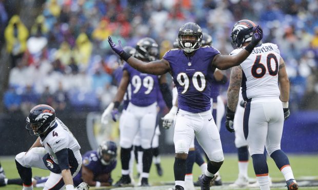 Za'Darius Smith #90 of the Baltimore Ravens reacts after knocking down Case Keenum #4 of the Denver...