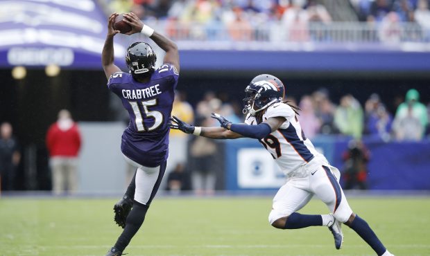 Michael Crabtree #15 of the Baltimore Ravens catches a pass against Bradley Roby #29 of the Denver ...