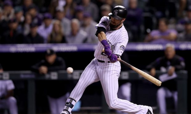 DENVER, CO - SEPTEMBER 25:  David Dahl #26 of the Colorado Rockies hits a RBI single in the seventh...