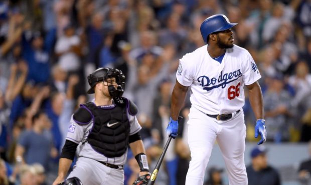 LOS ANGELES, CA - SEPTEMBER 19:  Yasiel Puig #66 of the Los Angeles Dodgers reacts to his three run...