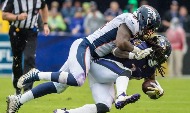 BALTIMORE, MD - SEPTEMBER 23: Todd Davis #51 of the Denver Broncos tackles Alex Collins #34 of the ...
