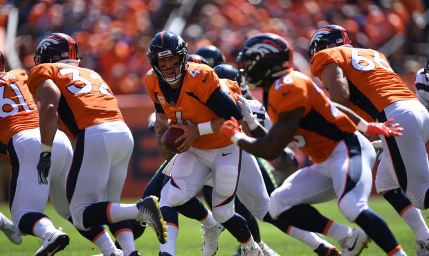 Denver Broncos quarterback Case Keenum (4) looks to hand off during the first quarter on Sunday, Se...