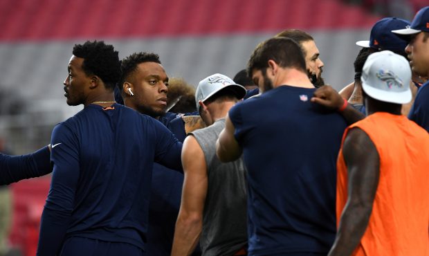 Demaryius Thomas #88 and Brandon Marshall #54 of the Denver Broncos in a huddle after warm ups befo...