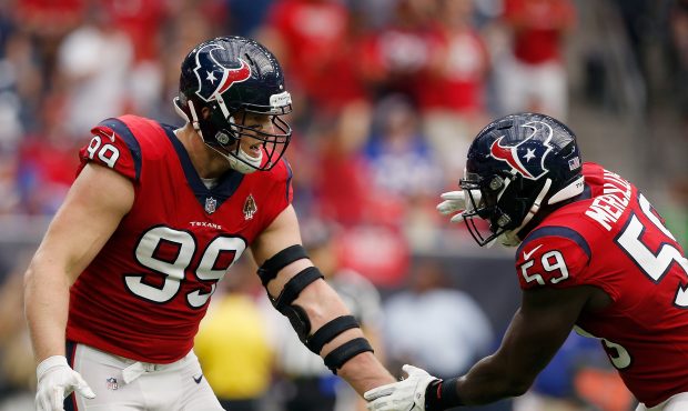 J.J. Watt #99 of the Houston Texans and Whitney Mercilus #59 shake hands after sacking Josh Allen #...