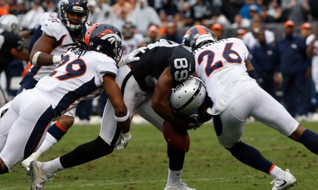 OAKLAND, CA - NOVEMBER 26: Amari Cooper #89 of the Oakland Raiders drops the ball as he is hit by D...