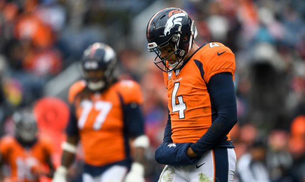 DENVER, CO - OCTOBER 14:  Quarterback Case Keenum #4 of the Denver Broncos hangs his head as he wal...
