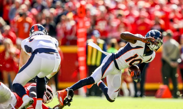 KANSAS CITY, MO - OCTOBER 28: Emmanuel Sanders #10 of the Denver Broncos is tripped up during the s...