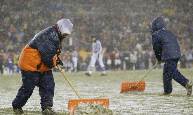 DENVER - NOVEMBER 24:  The turf crew shovels off the yardage lines before overtime between the Indi...