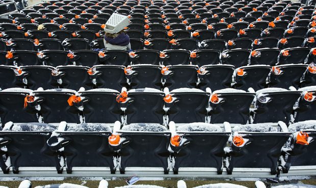 CHICAGO, IL - NOVEMBER 22:  A fan sits in snow covered seats prior to the NFL game between the Chic...