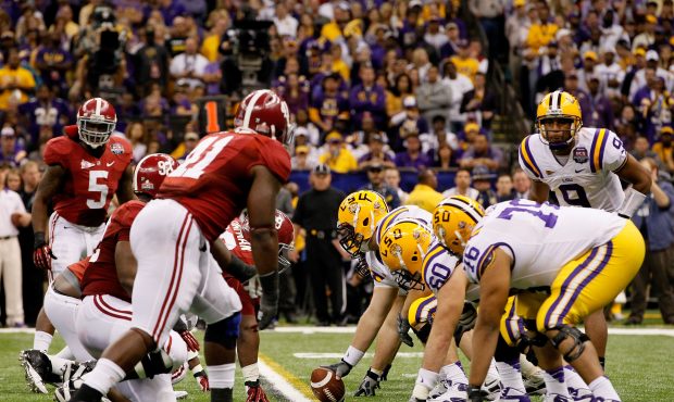 Jordan Jefferson #9 and the Louisiana State University Tigers line up against the Alabama Crimson T...