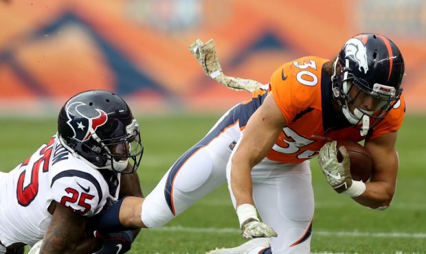 DENVER, CO - NOVEMBER 04:  Phillip Lindsay #30 of the Denver Broncos is tackled by Kareem Jackson #...