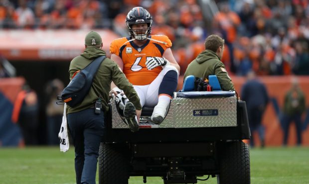 DENVER, CO - NOVEMBER 04:  Matt Paradis #61 of the Denver Broncos is driven off the field after bei...