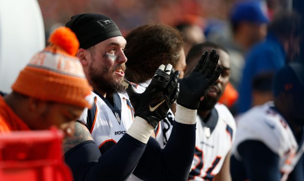 Derek Wolfe #95 of the Denver Broncos talks to teammates on the bench during the game against the S...