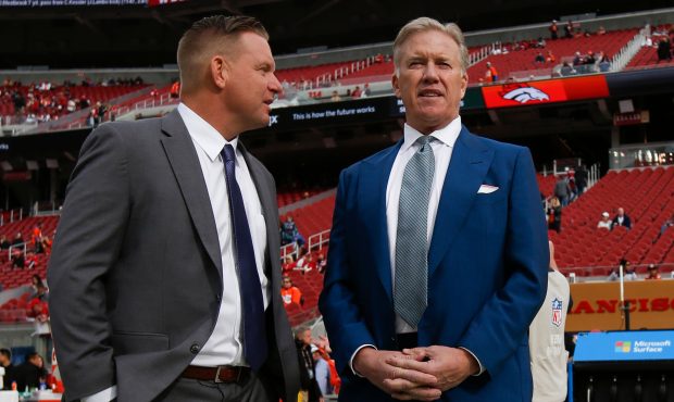 Denver Broncos general manager John Elway stands on the field prior to the game against the San Fra...