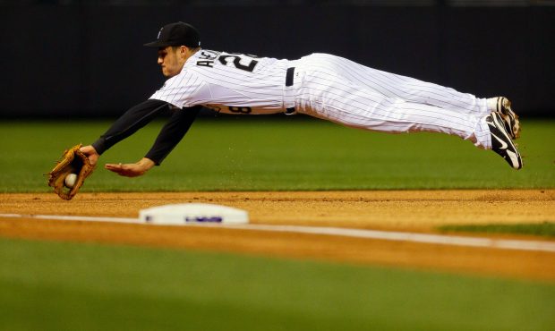 Third baseman Nolan Arenado #28 of the Colorado Rockies dives on an infield hit by Alex Guerrero (n...