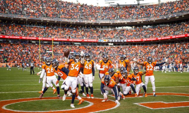 DENVER, CO - DECEMBER 30:  Denver Broncos players celebrate with strong safety Will Parks #34 after...