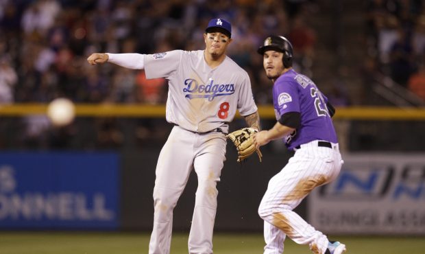Manny Machado #8 of the Los Angeles Dodgers and Nolan Arenado #28 of the Colorado Rockies watch as ...