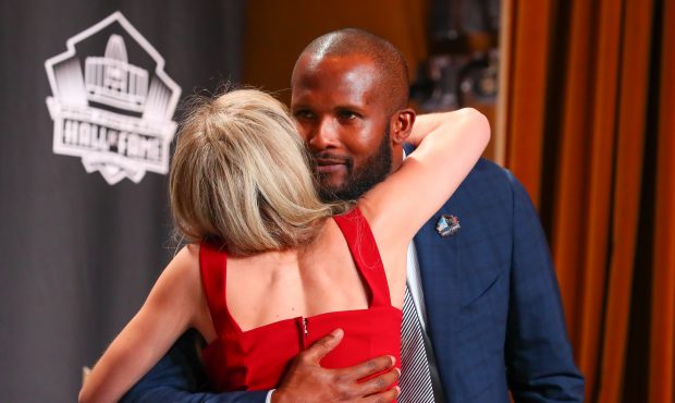 Pro Football Hall of Fame inductee Champ Bailey hugs Brittany Bowlen, representing her father, Denv...