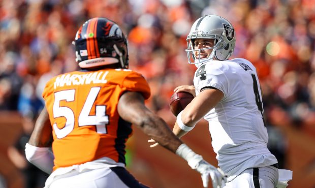 DENVER, CO - OCTOBER 1:  Quarterback Derek Carr #4 of the Oakland Raiders under pressure by inside ...