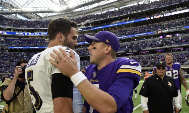 Quarterbacks Joe Flacco #5 of the Baltimore Ravens and Case Keenum #7 of the Minnesota Vikings gree...